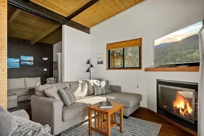 a living room with a couch and a fireplace at YOLO Lake Escape in Big Bear Lake
