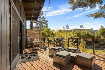 a deck with a table and chairs and a grill at YOLO Lake Escape in Big Bear Lake