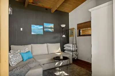 a living room with a couch and a table at YOLO Lake Escape in Big Bear Lake