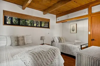 a bedroom with two beds and a window at YOLO Lake Escape in Big Bear Lake