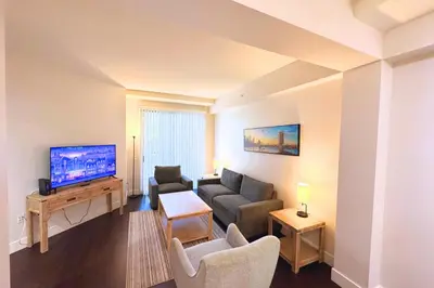 a living room with a couch and a tv at Cozy Apartment Homes On Wilshire Corridor in Los Angeles