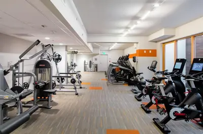 a gym with several treadmills and cardio machines at Cozy Apartment Homes On Wilshire Corridor in Los Angeles
