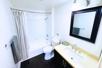 a bathroom with a sink and a toilet and a mirror at Cozy Apartment Homes On Wilshire Corridor in Los Angeles