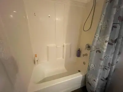 a white bathroom with a tub and a shower at Cabin 7 sleeps 8 BEAUTIFUL BOULDER BAY, BIG BEAR in Big Bear Lake