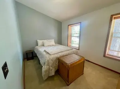 a small bedroom with a bed and two windows at Cabin 7 sleeps 8 BEAUTIFUL BOULDER BAY, BIG BEAR in Big Bear Lake