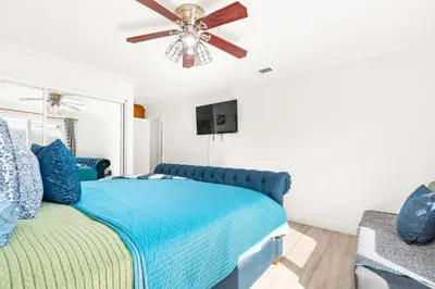 a bedroom with a blue bed and a ceiling fan at Gated 6beds 2garage home near Disney other LA attraction in Chino