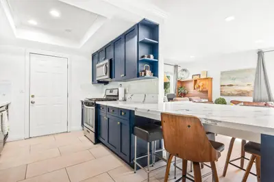 a kitchen with blue cabinets and a counter top at Gated 6beds 2garage home near Disney other LA attraction in Chino