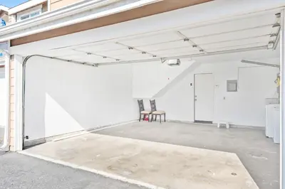 an empty garage with two chairs in it at 5bed 3bath Private gated community home 7miles to Downtown La close to Disney in Commerce