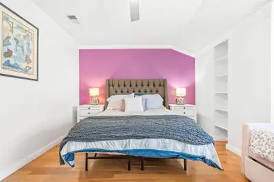 a bedroom with purple walls and a bed with two night stands at 5bed 3bath Private gated community home 7miles to Downtown La close to Disney in Commerce