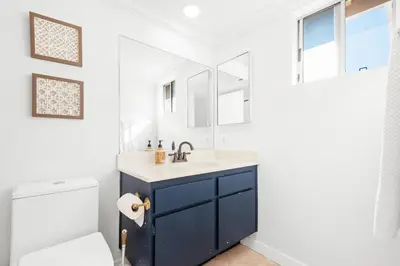 a bathroom with a sink and a toilet at 5bed 3bath Private gated community home 7miles to Downtown La close to Disney in Commerce