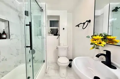 a bathroom with a toilet and a sink and a shower at Jies choice Contemporary Elegance in Altadena in Altadena