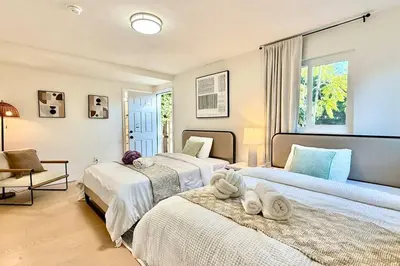 a bedroom with two beds and a window at Jies choice Contemporary Elegance in Altadena in Altadena