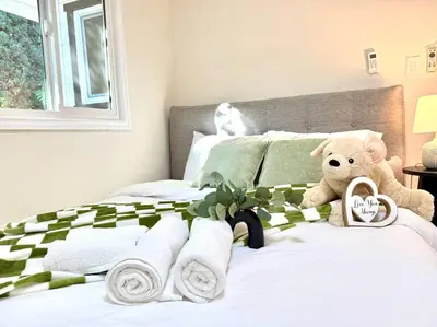 a teddy bear sitting on a bed with towels at Jies choice- Modern Luxe in Altadena in Altadena