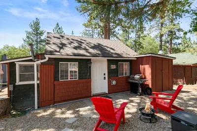 a tiny house with red chairs and a grill at Little Lux - Hot Tub, Walk to Village & Lake in Big Bear Lake