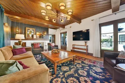 a living room with a couch and a table at Villa Encanto- LUXE Spanish Villa with 6 KING Bedrooms, Courtyard and New Game Room in Long Beach