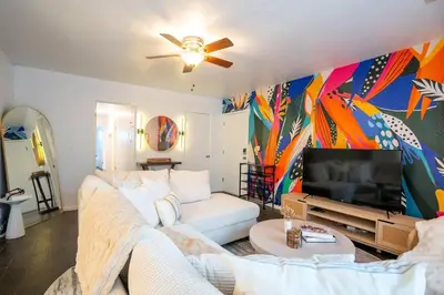 a living room with a couch and a tv at Stylish Cozy, Aesthetic, Stocked Kitchen, and Pet Friendly in Palmdale