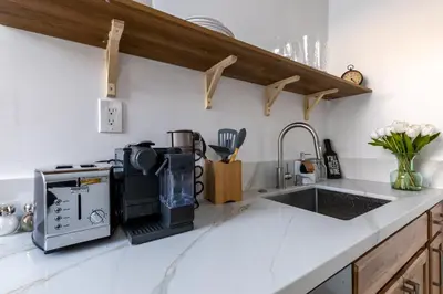 a kitchen counter with a coffee maker and a sink at Walking distance to Caltech convention Center Pasadena Landmark room in Pasadena
