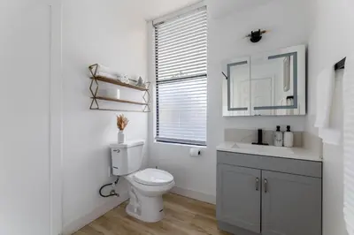 a white bathroom with a toilet and a window at Walking distance to Caltech convention Center Pasadena Landmark room in Pasadena