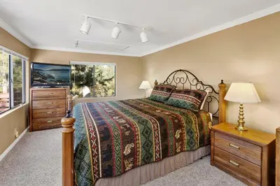 a bedroom with a bed and a dresser and a window at Mountain Hideaway on Maryland #2494 in Big Bear Lake