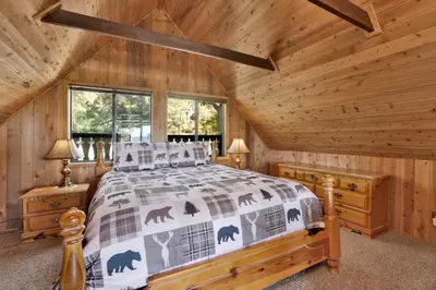a bedroom with a bed in a log cabin at Mountain Hideaway on Maryland #2494 in Big Bear Lake