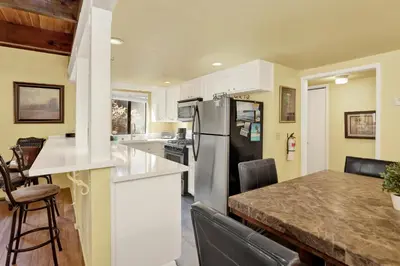a kitchen with a refrigerator and a counter top at Buttercup #2508 in Big Bear Lake