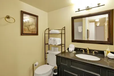 a bathroom with a sink and a toilet and a mirror at Buttercup #2508 in Big Bear Lake