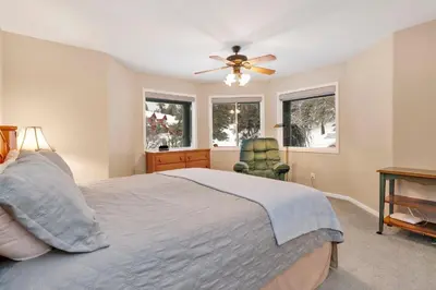 a bedroom with a bed and a ceiling fan at Castle Glen Gem #2220 in Big Bear Lake