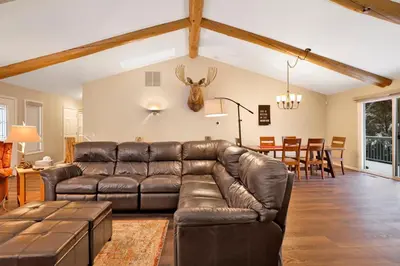 a living room with a leather couch and a dining room at Castle Glen Gem #2220 in Big Bear Lake