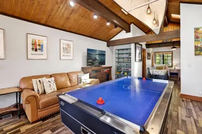 a large living room with a pool table at Serenity Cove Lake House #2472 by Big Bear Vacations in Big Bear Lake