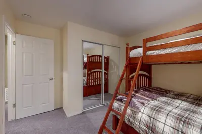 a bedroom with two bunk beds and a mirror at Cloud Nine in Lake Arrowhead