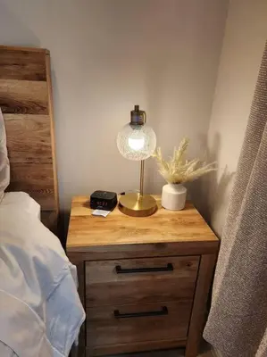 a nightstand with a lamp on it next to a bed at Spacious 1 Bed ADU in Encino, Home Away from Home in Los Angeles