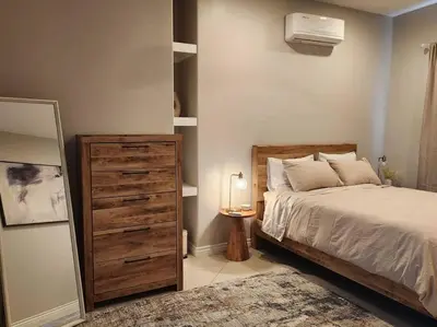 a bedroom with a bed and a dresser and a mirror at Spacious 1 Bed ADU in Encino, Home Away from Home in Los Angeles