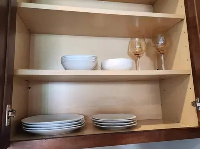 a cabinet with plates and wine glasses in it at Spacious 1 Bed ADU in Encino, Home Away from Home in Los Angeles