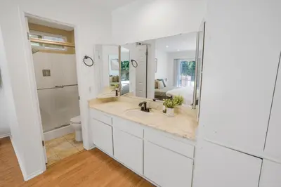a white bathroom with a sink and a shower at Spacious House, Central, All Amenities in Harbor City
