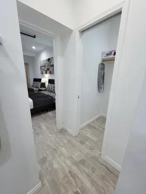 a bedroom with a bed and a room with a hallway at Modern Studio apartment right next to MrC hotel 5 minutes to Rodeo Drive in Los Angeles