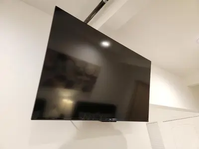 a flat screen tv hanging on a wall at Modern Studio apartment right next to MrC hotel 5 minutes to Rodeo Drive in Los Angeles