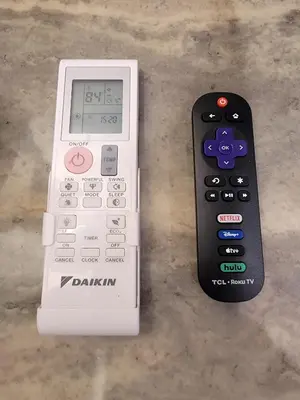a calculator and a remote control sitting on a table at Modern Studio apartment right next to MrC hotel 5 minutes to Rodeo Drive in Los Angeles