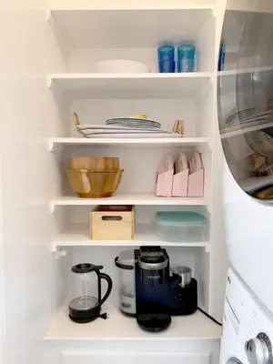 a kitchen pantry with white shelves and a coffee maker at The Culver Retreat Family Oasis w Office Backyard in Los Angeles