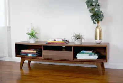 a coffee table with books and potted plants on it at The Culver Retreat Family Oasis w Office Backyard in Los Angeles