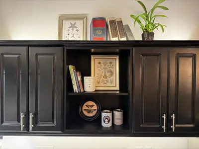 a black cabinet with books and cups on it at The Loft at Butler in Los Angeles