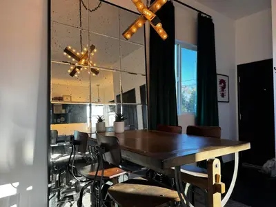 a dining room with a wooden table and chairs at The Loft at Butler in Los Angeles