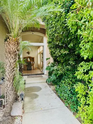 a palm tree in front of a building at Entire Fully Furnished Home in Camarillo California. 10 Mins from the beach in Camarillo
