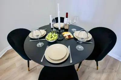 a black table with plates of food and wine glasses at Cozy 2BD Retreat in MarinaDelRey!Free Parking&Pool in Los Angeles