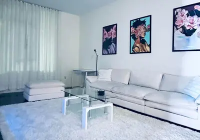 a living room with a white couch and a glass table at 1 br spacious in Hollywood in Los Angeles