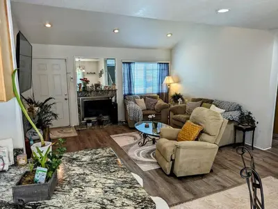 a living room with two couches and a fireplace at 5 Minutes to South Bay Beaches! Private 2 bedroom 2 bath 2 level home with patio Excellent value! in Torrance