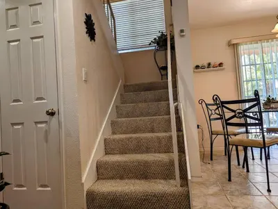 a staircase in a home with a table and chairs at 5 Minutes to South Bay Beaches! Private 2 bedroom 2 bath 2 level home with patio Excellent value! in Torrance
