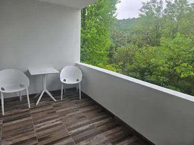 a balcony with two chairs and a table and a window at NEW 2BD Majestic Gateway in Glendale in Glendale