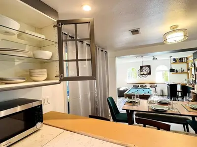 a kitchen and dining room with a table and chairs at Mediterranean Villa-Pool Jacuzzi BBQ-Malibu Bliss in Los Angeles