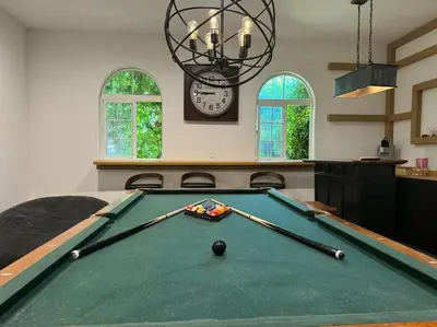 a pool table in a living room with a clock at Mediterranean Villa-Pool Jacuzzi BBQ-Malibu Bliss in Los Angeles