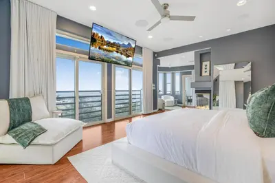 a bedroom with a large white bed and a tv at Franklin Mediterranean Villa in Los Angeles